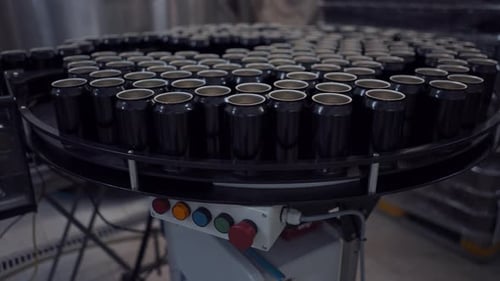Beer Cans On Moving Conveyor In A Beer Factory