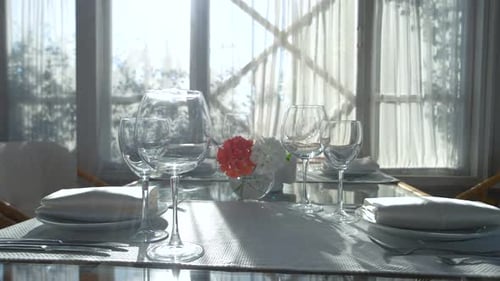 Elegant Table Setting with Flowers and Sunlight