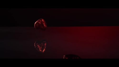 Valentine's Day decorations falling and bouncing on a reflective surface - VALENTINES 009