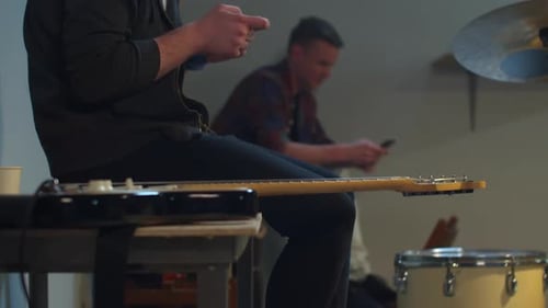 Young Adults Using Cell Phones in Music Room