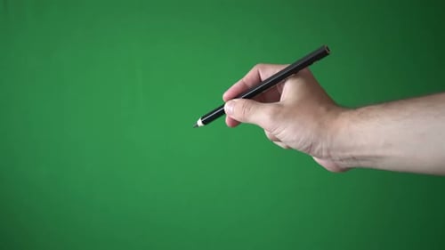 Man Holding Pencil In His Hand Isolated On Chroma Key Green Screen Background