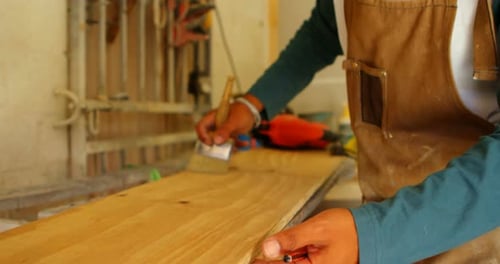 Surfboard maker polishing surfboard