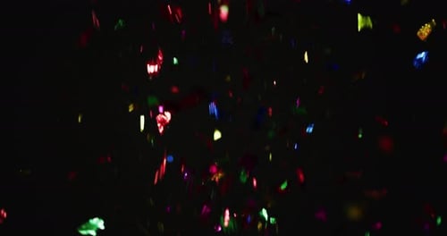 Colorful Confetti Falling on Dark Background