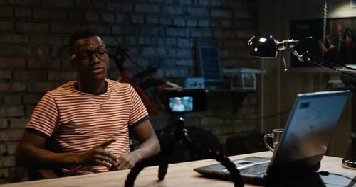 Young Man Talking on Camera in a Garage