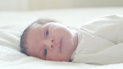 Close-up portrait of a young baby who has recently been born.