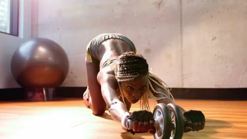 Fit woman exercising with dumbbell