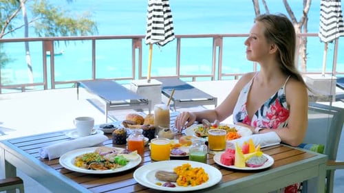 Young Woman Have Sunday Brunch in Outdoors Restaurant at Luxury Tropical Hotel in Sunny Summer
