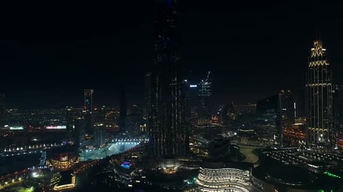Aerial view of Burj Khalifa Tower with a light show at night in Dubai.