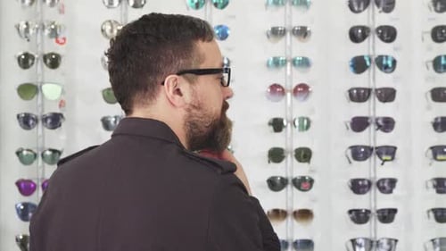 Mature Male Customer Choosing Glasses at the Eyewear Store