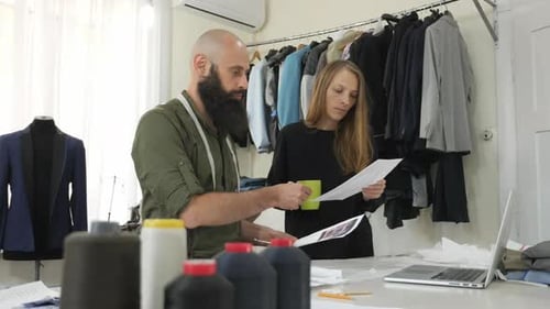 Tailor with assistant in the workshop