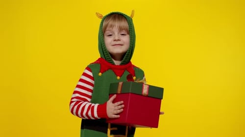 Happy Child Elf Presenting a Festive Christmas Gift