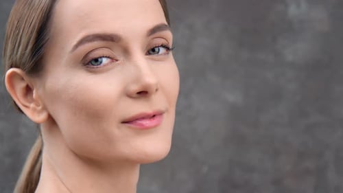 Pretty Female Model Tender Smooth Skin Posing at Black Studio Background