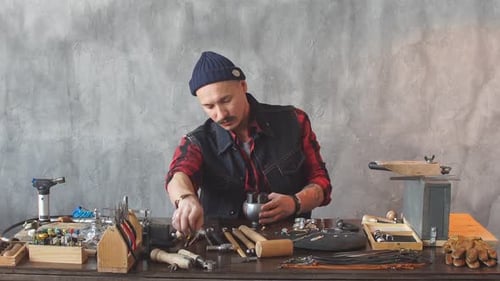 Young Ambitious Craftsman Fixing a Jewel in Earring.