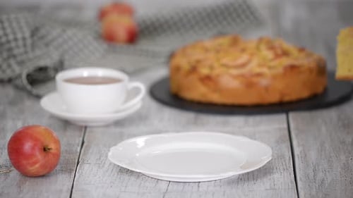 Serving Slice of Fresh Apple Cake with Tea