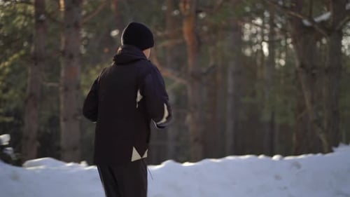 Child Running Through Snowy Winter Forest