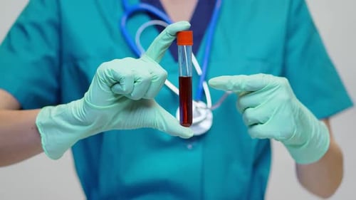 Medical Professional Holding Vial of Blood