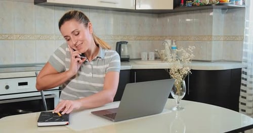 Woman Works From Home in Bright Kitchen