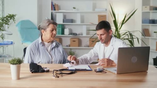 Female Patient Consults with Doctor in Office