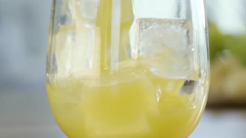 Chilled Juice being Poured into Glass with Ice