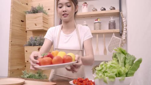 Woman Preparing Fresh Vegetables in Bright Kitchen
