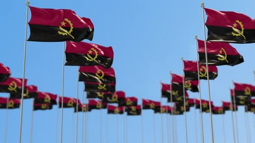 Angolan Flags Waving Against Clear Blue Sky