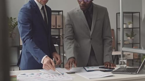 Financial Review by Two Adults in Modern Office