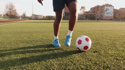 Soccer Player Practicing Kicks on Urban Field