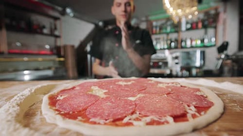 Close Up of Ready Pizza with Sauce Cheese and Sausage