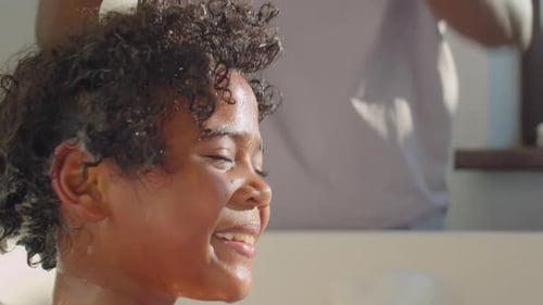 Father Gives Child a Bath with Bubbles