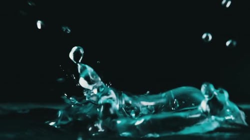 Many Drops of Water Fall on the Surface of the Water in Slow Motion Macro Shot