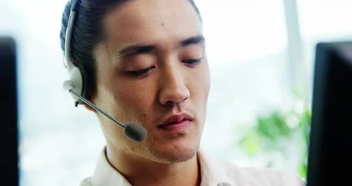 Young Adult Call Center Employee Speaking with Headset