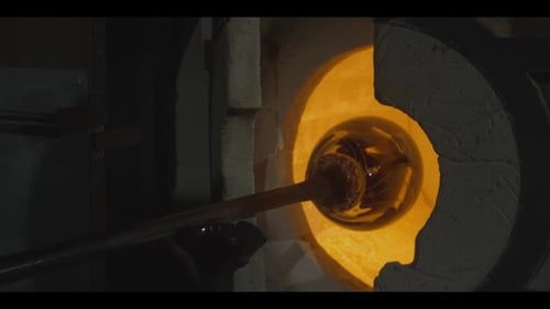 Glassblowing: shaping molten glass in a hot furnace