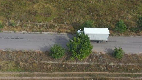 Aerial Shot of Truck with Cargo Trailer Driving on Road and Transporting Goods. Flying Over Delivery