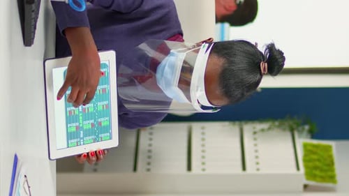 Woman Works on Tablet Wearing Face Mask in Office