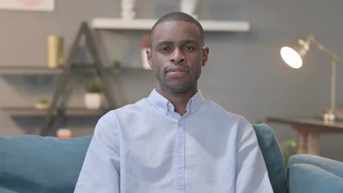 Person sitting on couch indoors