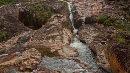 Camera Moves From Pool To Stormy Stream Top Against Plants