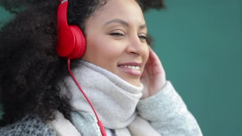 Woman with Red Headphones Enjoys Music