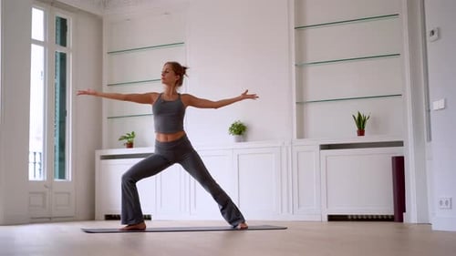 Young Woman Practices Yoga Flow Sequence at Home