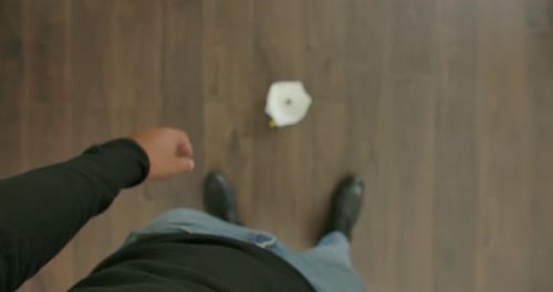 Adult Inspecting White Filtration Mask Before Dropping It