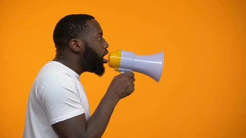 African-American Man Using Megaphone for Protest, Calling to Action, Side View