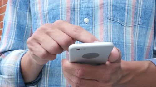 Adult Using Smart Phone in Urban Environment