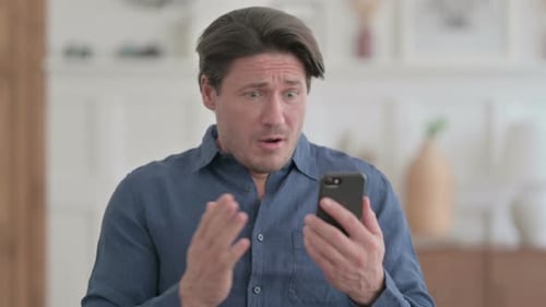 Sad Man Using Smartphone Looking Upset