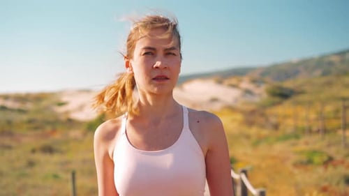Woman Walking Near Beach on Sunny Day