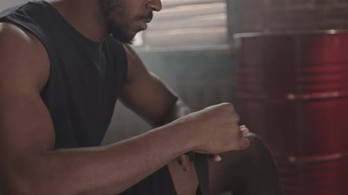 Man Wrapping Hands for Boxing Training Indoors