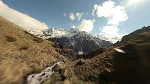 Drone Shot Down a Waterfall Along the Mountain Dew Towards to Beautiful Valley