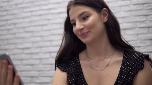 Young Woman Chatting on Video Call with Tablet