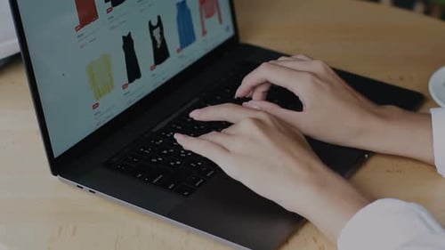 Woman Arms Typing on Computer at Wooden Table