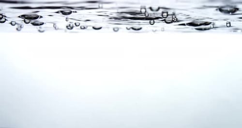 Water and Bubbles Entering Clear Water