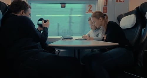 Family Riding Train Together on Winter Journey