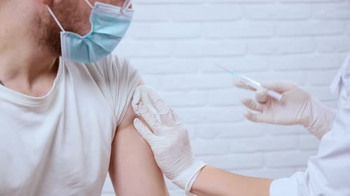 Doctor Giving an Injection to an Adult Patient